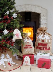 Decorated Christmas Tree and fireplace with present sacks