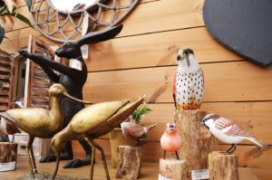 Carved wooden birds on a log pedestal