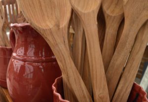Wooden spoons in a red vase