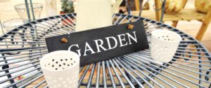 Metal garden table with "Garden" sign