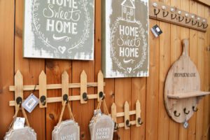 Wall hooks on a picket fence. Home sweet home canvas