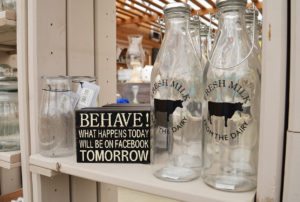 Milk bottles. Behave! What happens today will be on Facebook tomorrow sign