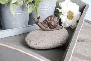 Decorative porcelain snail on a stone