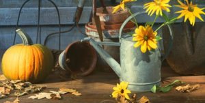 Watering can with yellow flowers and a pumpkin
