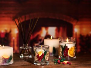 Decorative candles in front of fireplace